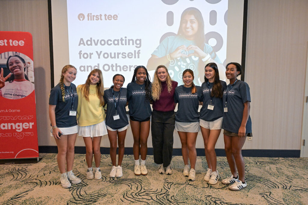 Attendees at the First Tee Girls' Academy pose with speaker Katie Goepel of the PGA Tour.